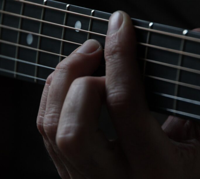 person using guitar